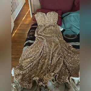I am selling my prom dress. It is a gold sequence mermaid size 18 built in bra.